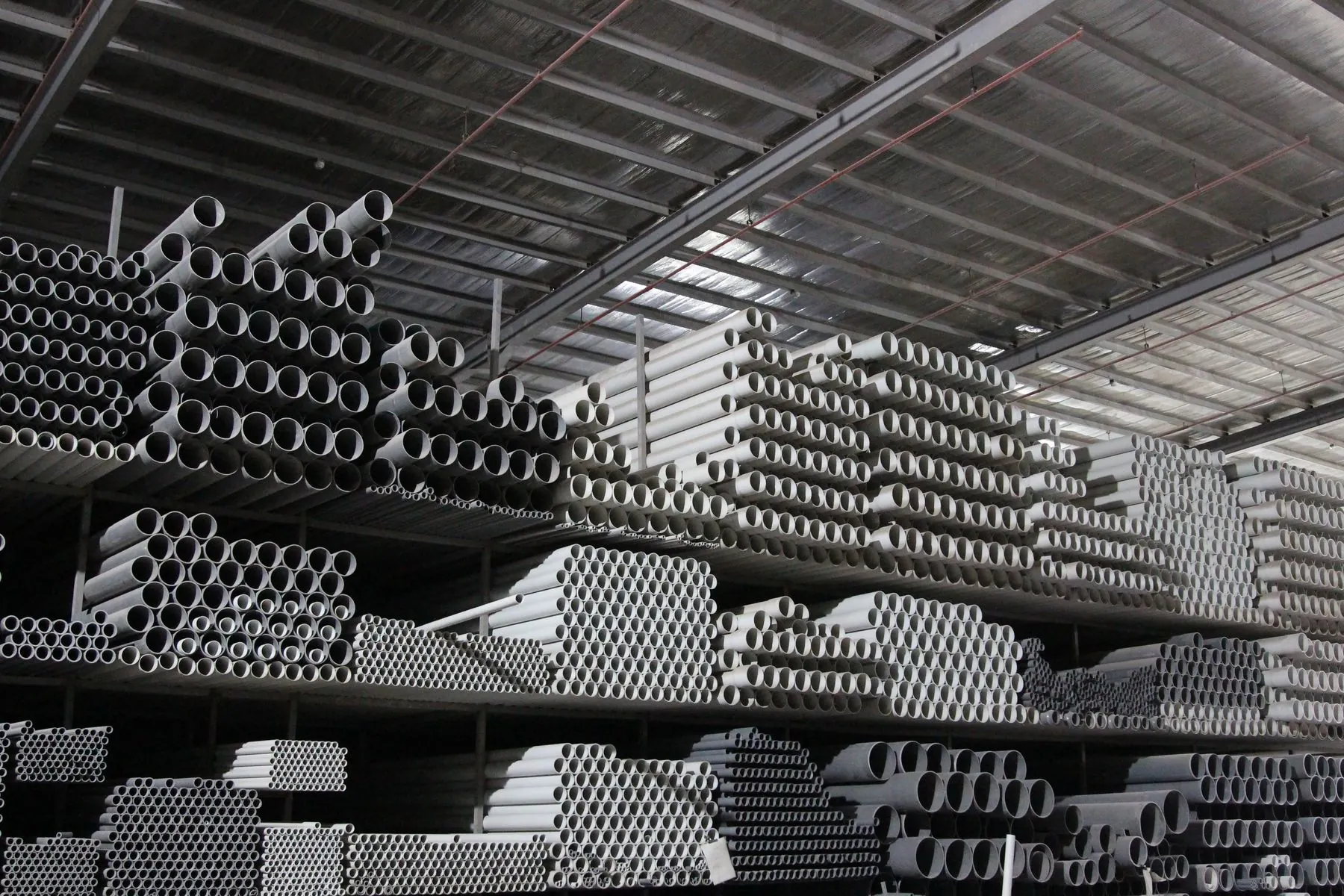 Multi-tier warehouse racking filled with ALFA pipe inventory