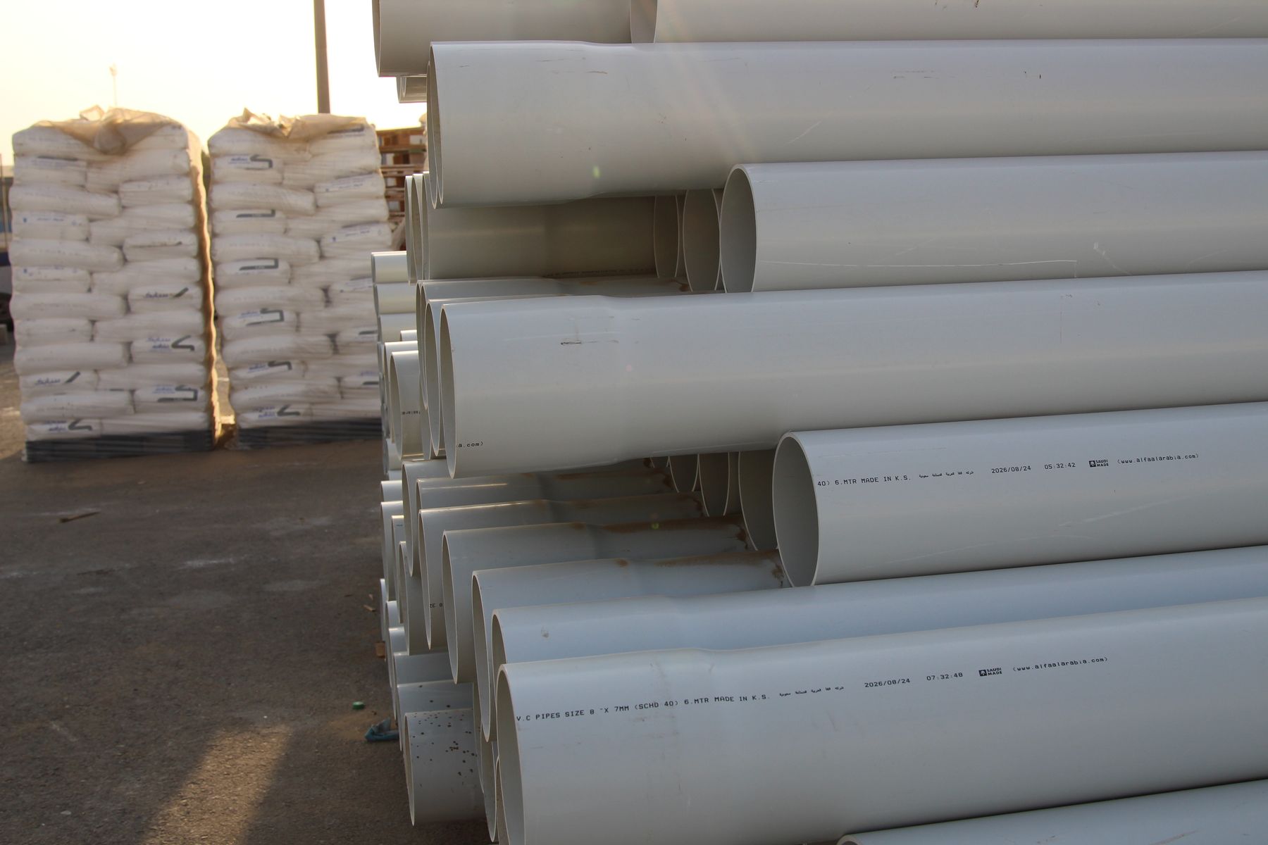 ALFA uPVC Schedule 40 pipes stacked in yard — Made in K.S.A.
